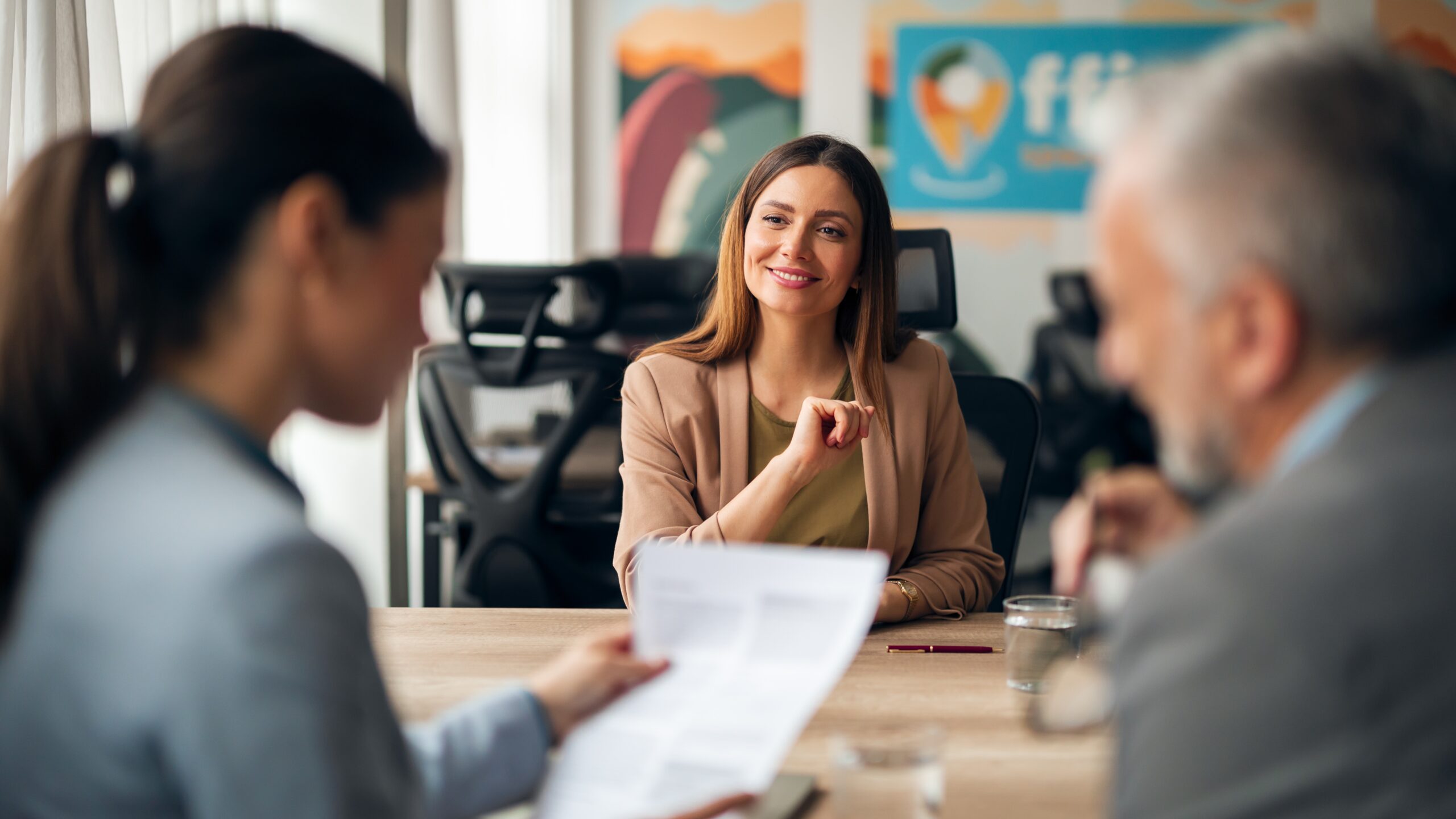 Job candidate smiling confidently during a professional interview with two panel members